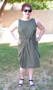 It features both a sleeveless or sleeve design with a round neckline, wrap laced closure at the waist, and a slim skirt with a vent in the back or cropped pants. Byrdie Couture Kielo Wrap Dress
