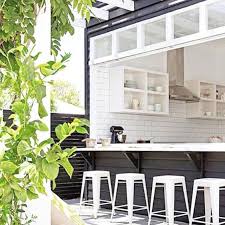 Wisteria emerson counter stools designed at an indoor/outdoor kitchen island with a peninsula bar featuring white and gray. 25 Smart Outdoor Bar Designs For Every Space Digsdigs