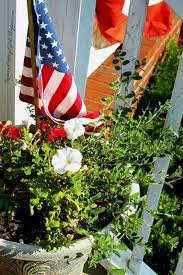 Putting a flagpole in your yard doesn't have to mean that the space around the pole must become a gardening desert. Independence Day Decor