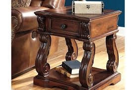 The Shapeliness Of Alymere End Table S Serpentine Legs Is Beautifully Contrasted By A Linear Tabletop Stow Odds End Tables Rustic End Tables Ashley Furniture