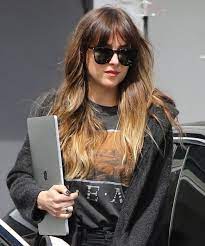 Dakota Johnson Goes Blonde With New Summery Highlights Dakota Johnson Hair Hair Color Light Brown Dakota Johnson Bangs