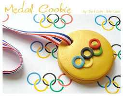 Use a smaller punch to make a hole in the top and thread your ribbon through. Olympic Medal Cookies