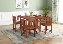 The table has a central pedestal that allows for plenty of legroom and strikes a stylish silhouette. Buy Cohoon 4 Seater Dining Set Honey Finish Online In India Wooden Street