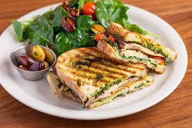Pesto and mozzarella panini, paneer bhurji panini, tomato basil mozzarella panini, roasted bell pepper and feta cheese panini, mushroom cheese and spring onions panini, chocolate peanut butter banana panini. Vegan Panini Portabella Lunch Dinner Urth Caffe Coffee Shop