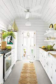 Wall And Ceiling Paneling In Touch Of Grey By Devoe Paint Makes This Small Cottage Kitchen Airy Beach House Kitchens Small Cottage Kitchen Beach House Interior
