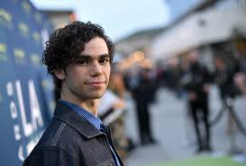 Cameron Boyce smiling at the camera.
