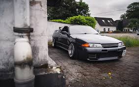 Find over 100+ of the best free nissan gtr r32 images. Hd Wallpaper Black Sports Coupe Parked Near White Wall Nissan Skyline Nissan Skyline R32 Wallpaper Flare