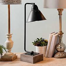 A table lamp's cozy and soothing lighting creates an intimate conversation space, inspirational workspace and stylish statement, all at the same time. Louis Matte Black Metal And Wood Table Lamp Kirklands
