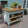 The design includes a large workspace, a lower open shelf and rather than breaking the budget on an expensive countertop, the island got a custom concrete top that looks great with the modern design. 1