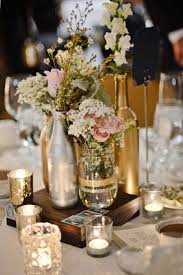 Rustic mint wine bottle and a wine wrapped bottle simple beautiful wine bottle centerpieces with ribbon and bold yellow flowers whitewashed wine bottle centerpiece for a wedding Romantic Wedding Centerpiece With Wine Bottles And Candles Oh Best Day Ever