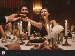 All other numbers are incorrect. Smiling Woman Passing Food To Friends Sitting Around Dining Table At Dinner Party Friends Enjoying Food At A Gala Dinner Party Stock Photo Offset