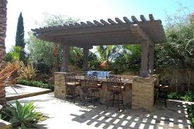 This attractive outdoor bar features wine barrels for the base and a spectacular piece of reclaimed wood for the bar countertop. Bbq Area Outdoor Bbq Area Outdoor Kitchen Patio Backyards Outdoor Bbq