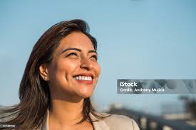 Closeup Of A Latina Woman Smiling Sideways Copy Space Stock Photo