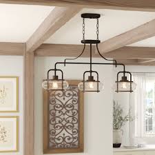 It's made from metal in a matte black finish, with the shade featuring decorative slots that allow extra light to filter through. Light Pendant For Kitchen Island Novocom Top