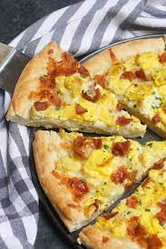 Easy Breakfast Pizza Recipe Begins With Homemade Pizza Dough Topped With Crisp Bacon Bits Scramble Breakfast Pizza Breakfast Pizza Recipe Smoked Food Recipes
