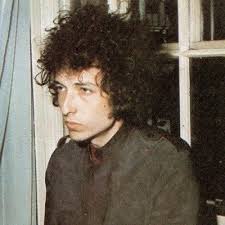 bob dylan performing at maple leaf gardens in toronto, ontario, shot by paul  till, january 9th, 1974. this photograph was later edited and colored by  till, to be used for the “blood