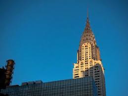 Art deco architectural style with terraced crown and recognized spire, chrome plating, stainless steel exteriors. Chrysler Building New York