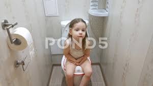 Happiness in childs eyes entertainment, leisure. A Little Girl Sitting On The Toilet The Stock Video Pond5
