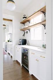 Kim, i love the glass shelves! Salvaged Wood Shelves With Iron Corbels Placed In Front Of Window Transitional Kitchen