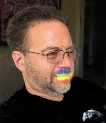 My dad semt me tiis photo this morning. I was sitting in just the right  spot for one of his prisms to hit me right in the mouth with a tiny rainbow.