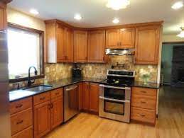 Flooring is the oak strip with a an outstanding example of uba tuba granite with shaker cherry golden honey color cabinets. Project Gallery Advanced Kitchens