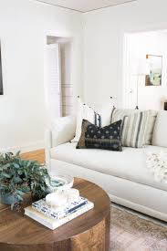 White Couch In A Boho Styled Living Room With A Round Wood Coffee Table Design Shop Interiors Trendy Living Rooms Living Room White Living Room Designs
