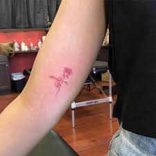 Red Ink Rose Tattoo On The Right Inner Arm Red Ink Tattoos Red Tattoos Tattoos
