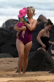 Katy stands underneath an umbrella with daisycredit: Katy Perry Flaunts Post Baby Body As She Enjoys Beach Day With Daughter And Orlando Bloom Ok Magazine