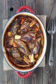 Spiced lamb shanks cooked in a red wine and tomato sauce with vegetables, aromatics and fresh herbs! Roasted Lamb Shanks Greek Style
