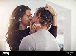Your kisses make me melt. Shot of a young couple making out in the kitchen  Stock Photo - Alamy