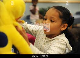 Air Force Tech Sgt. Ariel VanWinkle with the 125th Medical Detachment walks  through a Mexico Beach neighborhood in search of residents in need of  medical attention. She is a member of the