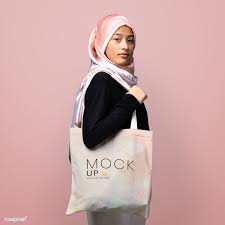 Download Download Premium Psd Of Muslim Woman Carrying A Tote Bag Mockup 2210632 Bag Mockup Muslim Women Blank Tote Bag