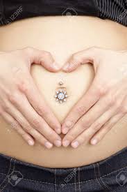 One reason that a belly button can become discolored is because you are pregnant. Pregnant Young Teen Woman S Tummy With Piercing In Belly Button Stock Photo Picture And Royalty Free Image Image 61448256