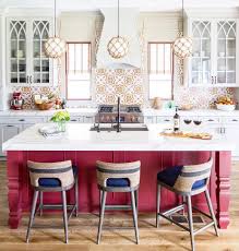 An oversized kitchen island with waterfall quartz countertop is the stunning centerpiece of this open concept kitchen. 3 Contrasting Kitchen Island Ideas