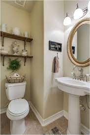 Add a feminine touch to your farmhouse half bath by hanging a ticking stripe fabric skirt below your vanity. 43 Perfect Farmhouse Half Bath Ideas That Will Impress You Homenthusiastic French Country Bathroom Country Bathroom Designs French Country Decorating