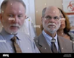 l to r) Dr. Edward Desmond, the chief of mycobacteriology, talks about  tuberculosis test, as Dr. Mark Horton, the director of the new Department  of Public Health, listens in at the new