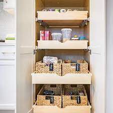 You can keep all your pantry stuff in the pullouts between ovens a bread drawer with a ventilated lid can make bread loaf fresh and safe. Kitchen Cabinet Stacked Pull Out Pantry Drawers Design Ideas