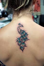 Beauty for the body with the lavish peacock designer tail tattoo. The Eye Catching Peacock Tattoo Designs For A Colorful Life