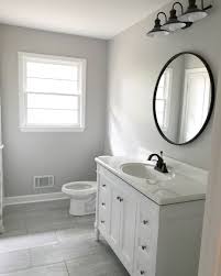 White And Gray Bathroom With Black Circle Mirror White Cabinets With Black Hardware Badkamer