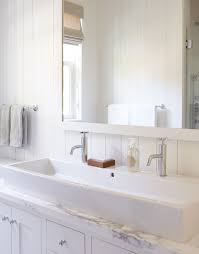 white bathroom with trough sink for two