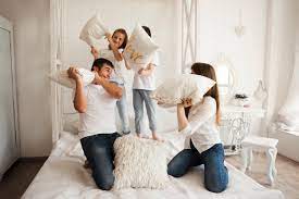 Telling amazing, inclusive stories with beautiful. Free Photo Playful Family Having Funny Pillow Fight On Bed