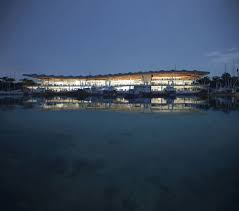 The new sydney fish market, set on a 3.6 hectare site on blackwattle bay, will separate tourists from the industrial activities, but keep the seafood market the large single roof made from timber and aluminium will rise and fall along with the building below. 3xn Sydney Fish Market