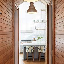 Warmer hues for this second oﬀering with a central island: Kitchen Island Paneling Design Ideas