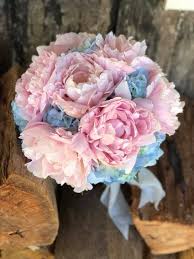 This gorgeous bridal bouqet is made with blue hydrangea and stunning white peonies. Bridal Bouquet Of Blue Hydrangea And Pink Peony Created By Lovely Bridal Blooms Pink Peonies Bouquet Bridal Bouquet Pink Hydrangea Bridal Bouquet