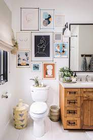 The use of lithographic and black and white art on the walls enhances the etched quality of this room. 15 Bathrooms With Beautiful Wall Decor That Will Inspire A Refresh