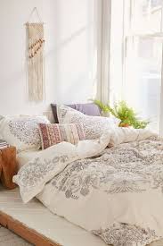 A bright feminine bedroom with a cnaopy bed, a wooden bench and a woven chair, a statement plant and a floral chandelier. Feminine Bedroom Ideas For A Mature Woman Theydesign Net Theydesign Net