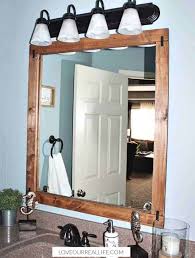 Today i'm sharing an older project that's still going strong in our entryway. How To Build A Diy Frame To Hang Over A Bathroom Mirror Love Our Real Life