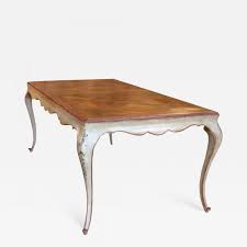 The round table top is a beautiful elm wood that has been treated to look antique and weathered with dark woodgrain, medium woodgrain, and streaks of sanded white woodgrain. Versailles Parquet Top Dining Table