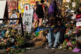 A protester holds a sign with an image of george floyd. George Floyd From I Want To Touch The World To I Can T Breathe The New York Times