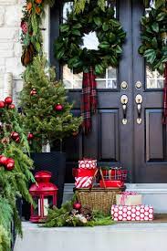 Flank the front steps with identical potted plants to achieve a balanced look that draws the eye without appearing too busy. Creative Front Porch Christmas Decorations The Garden Glove